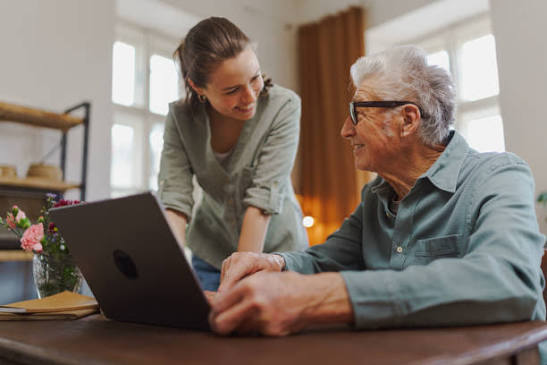 A volunteer helping a senior with their phone